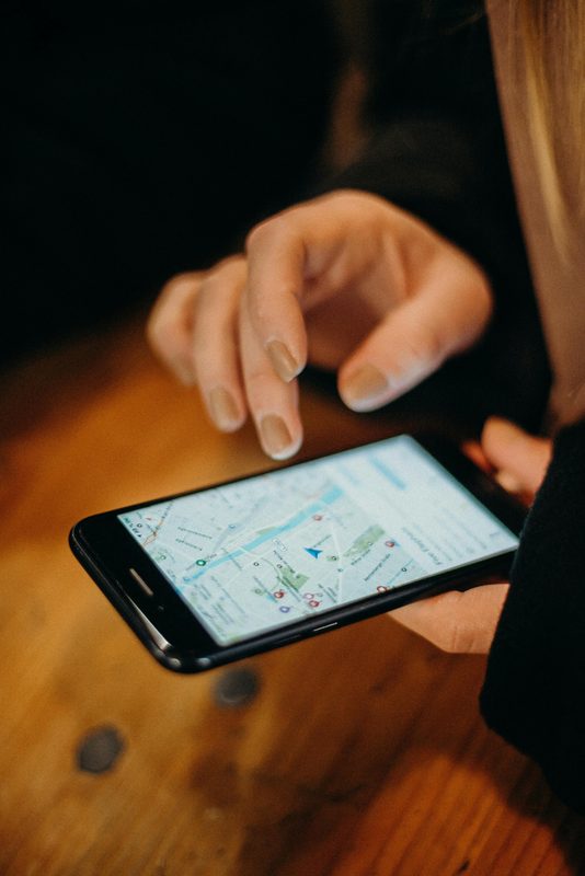 Small business owner searching on Google Maps on a smartphone